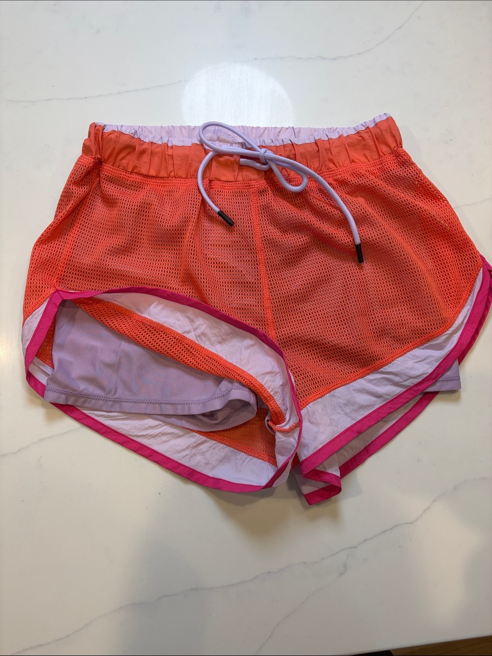 Women’s Orange Mesh Athletic Shorts with Pink Trim and built-in shorts